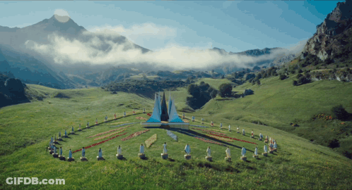 Group Of People Standing In Circle In Grassy Field GIF