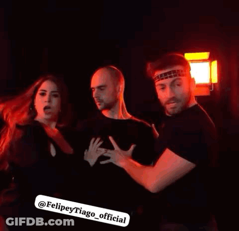 Group Of People Standing In Dark Room GIF