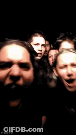 Group Of People Standing In Dark Room With Mouths Open GIF