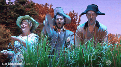 Group Of People Standing In Field Of Grass GIF