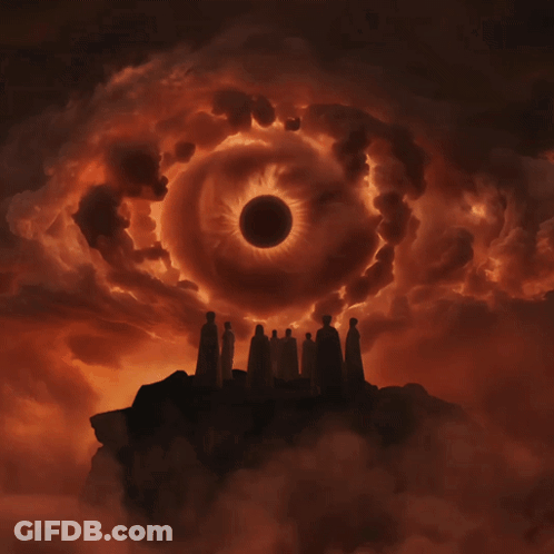 Group Of People Standing In Front Of An Eclipse GIF