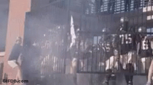 Group Of People Standing In Front Of Building GIF