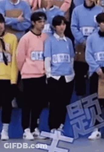 Group Of People Standing In Front Of Crowd GIF