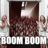 Group Of People Standing In Front Of Door With Boom Boom GIF