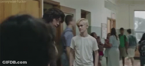 Group Of People Standing In Hallway GIF
