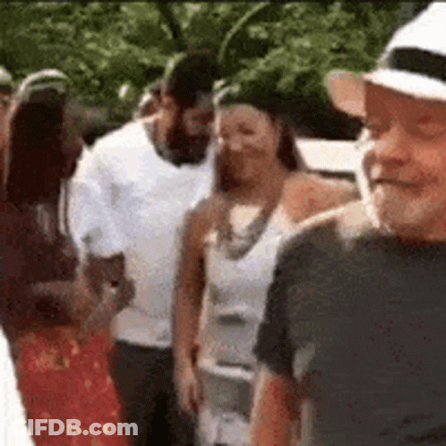 Group Of People Standing In Line One Wearing Hat GIF