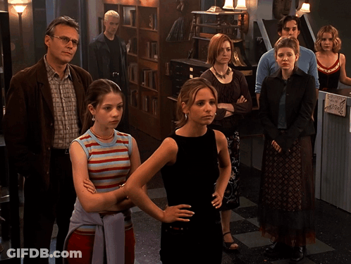 Group Of People Standing In Room Saying We're Family GIF