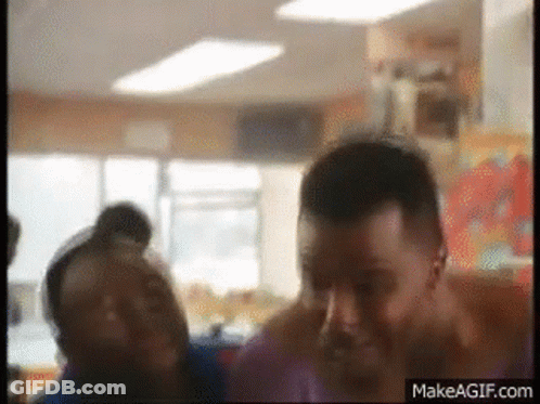 Group Of People Standing In Room With Makeagif.com Logo GIF