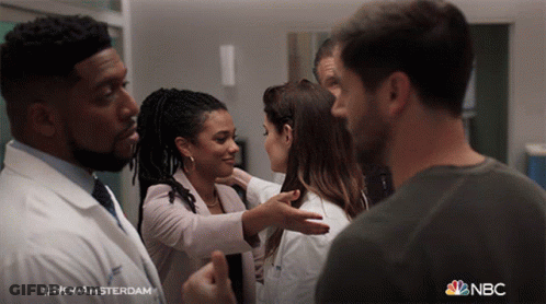 Group Of People Standing In Room With NBC GIF