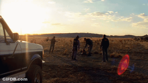 Group Of People Standing Near Van In Field GIF