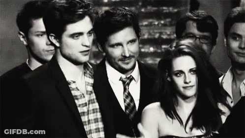 Group Of People Standing Next To Each Other In Room GIF
