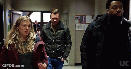 Group Of People Walking Down Hallway With UC GIF