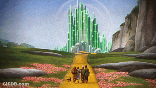 Group Of People Walking Down Yellow Road Towards Green Castle GIF