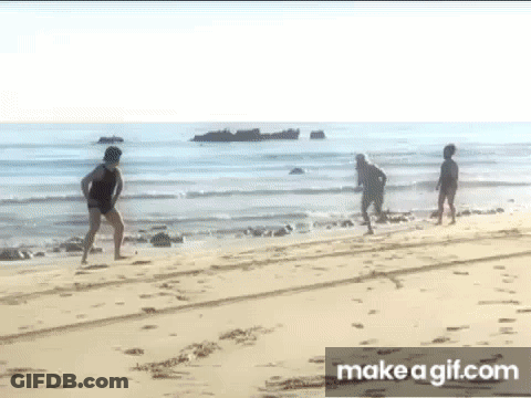 Group Of People Walking On Beach GIF