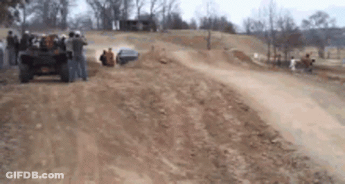 Group Of People Watching Jeep On Dirt Track GIF