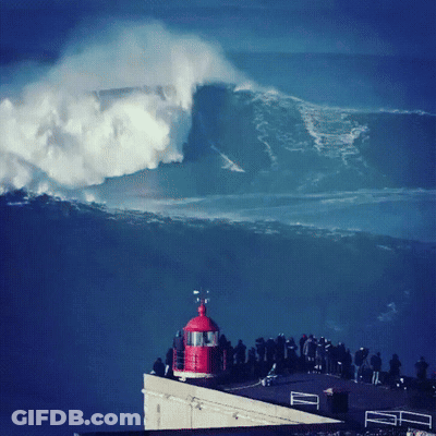 Group Of People Watching Wave Crash From Building GIF