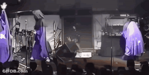 Group Of People With Purple Umbrellas On Stage GIF
