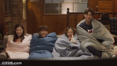 Group Of People Wrapped In Blankets Watching A Movie GIF