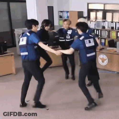Group Of Police Officers Holding Hands In Office GIF