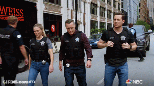 Group Of Police Officers Walking In Front Of Weiss Security Transport Truck GIF