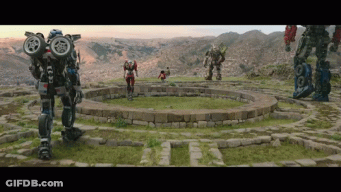 Group Of Robots Around Stone Circle In Field GIF
