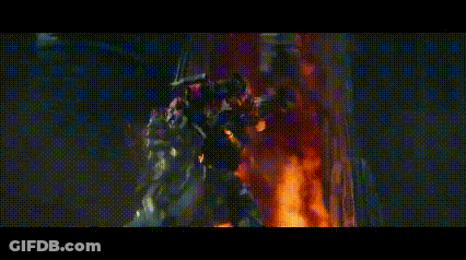 Group Of Robots In Front Of Burning Building GIF