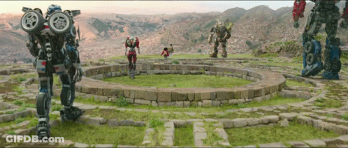 Group Of Robots Standing In A Circle In A Field GIF