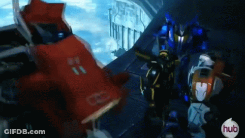 Group Of Robots Standing Together In A Room GIF