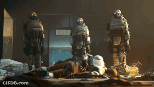 Group Of Soldiers In Gas Masks Around Fallen Soldier GIF
