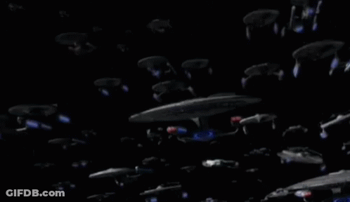 Group Of Spaceships Flying In Dark Space GIF