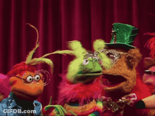 Group Of Stuffed Animals On Stage With Red Curtain GIF