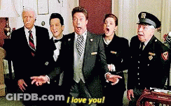 Group Of Suited People Standing Around Man In Suit GIF