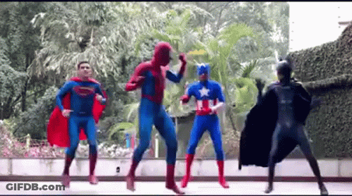 Group Of Superheroes Dancing On Sidewalk GIF
