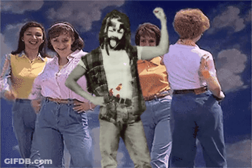 Group Of Women Around Bearded Man GIF
