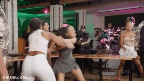 Group Of Women Fighting While Man Stands Behind GIF