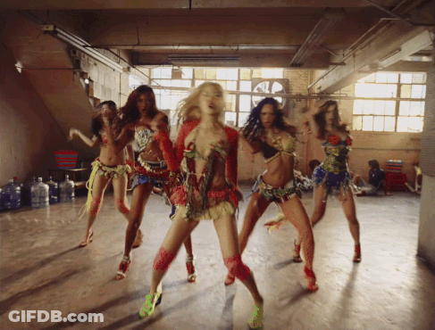 Group Of Women In Colorful Outfits Dancing GIF