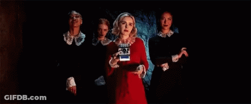 Group Of Women In Dark Room One Holding Camera GIF