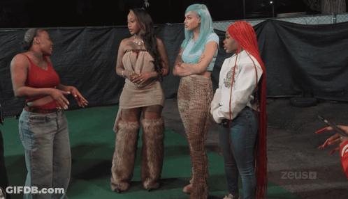 Group Of Women In Front Of Fence With Zeus GIF