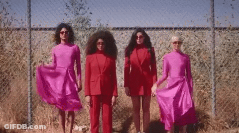 Group Of Women In Red By Chain Link Fence GIF
