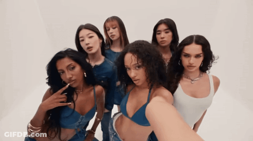 Group Of Women Posing, One In Bikini Top GIF