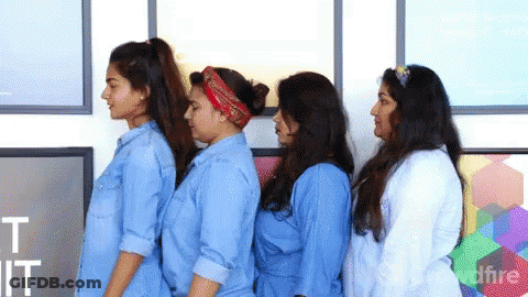 Group Of Women Standing In Front Of Wall Saying It GIF