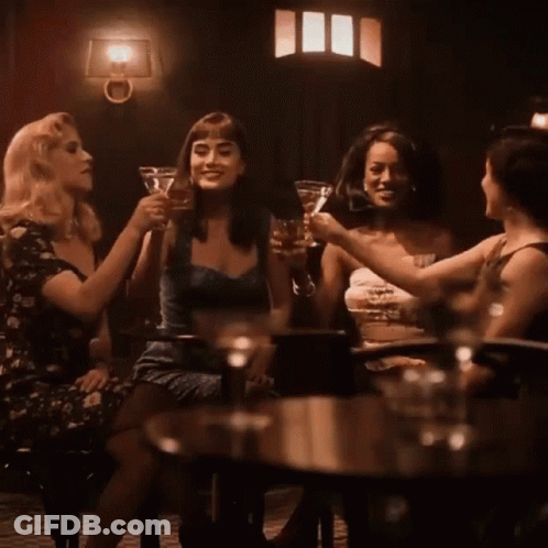 Group Of Women Toasting At Table GIF