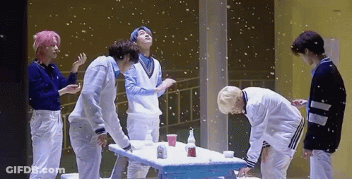 Group Of Young Men Around Snow-Covered Table GIF