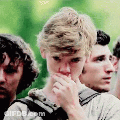 Group Of Young Men Covering Mouths Standing Together GIF