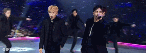 Group Of Young Men Holding Microphones On Stage GIF