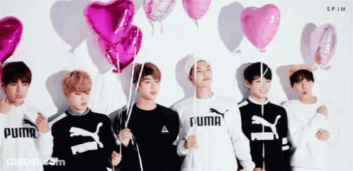 Group Of Young Men Holding Pink Balloons GIF
