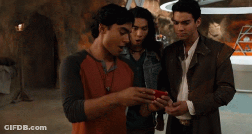 Group Of Young Men Looking At Cell Phone GIF