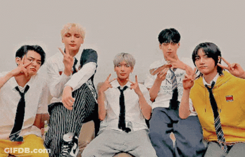 Group Of Young Men Posing One In Yellow Sweater GIF