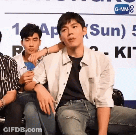 Group Of Young Men Sitting By Sun Sign GIF