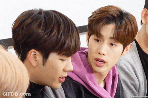 Group Of Young Men Sitting Next To Each Other One Wearing Pink Hoodie GIF